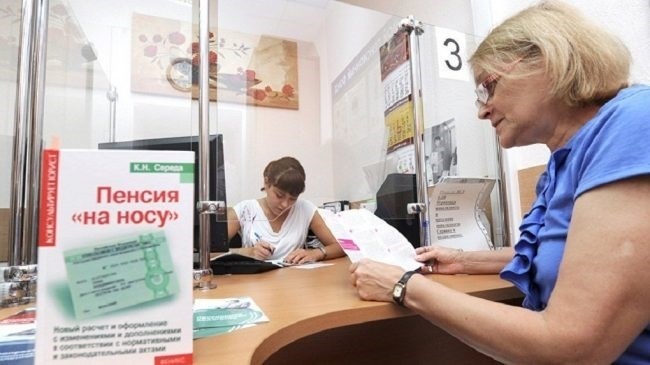 Пожилая женщина получает консультацию в офисе государственных услуг 